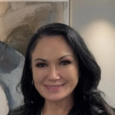 Saturn Turnbull, photographed in front of a framed painting.